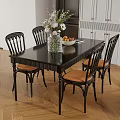 Black Top Dining Table Set with Four Wooden Chairs Decorative Vase Fruit Bowl in Kitchen