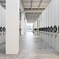 White Mobile Shelving Units With Black Circular Handles And Open Compartments In Industrial Storage Room