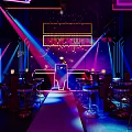 Vibrant Bar Interior With Neon Lights Laser Beams And Colorful Bar Stools