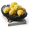 Fresh Lemons On Black Plate With Spiky Edges On An Organic Book And Small Spoon