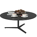 Black Round Coffee Table With Two Coffee Cups White Saucers Books And Pinecone Bowl