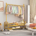 Golden Clothes Rack With Multiple Hanging Clothes Storage Shelf Near Sofa And Sunflower Decor