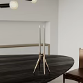Minimalist Modern Brass Tripod Candle Holder With Two Candles On Dark Wooden Dining Table