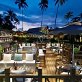 Outdoor Restaurant With Palm Trees Wooden Deck And Comfortable Sofa Seats