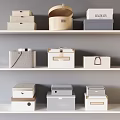 Home Storage Boxes in Various Colors and Textures on White Shelves for Organizing Home Supplies