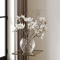 Clear Glass Vase With White Magnolia Flowers Arranged On Side Table Near Window