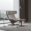 Modern Lounge Chair With Ottoman And Side Table By Large Window With Greenery