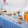 Hotel Public Lounge with Buffet Table Full of Desserts Drinks and Fresh Flowers