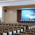 Modern Conference Room With Rows Of Seats Ceiling Lights And Wooden Panel Background