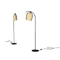 Two Modern Floor Lamps With Golden Shades And Black Stands In Bright Interior