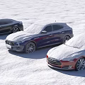 Three Snow Covered Black Blue And Red Cars Parked On Snowy Ground