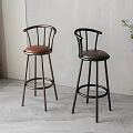 Two Modern Bar Stools With Brown And Black Leather Seats And Metal Frames Indoor