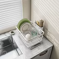Dinnerware Set in White Rack with Green White Plates Glass Cups on Marble Kitchen Countertop