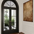 Black Arched Double Door With Glass Panes Golden Handles And Green Plants View