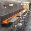 Modern Restaurant Interior With Red Brick Walls Black Orange Booth Seats And Metal Tables Chairs