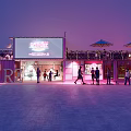 Pink Container Building With Large Wonderland Screen And People In Evening Plaza
