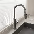 Contemporary Kitchen Sink Featuring Sleek Faucet And Window Blinds On Countertop