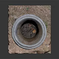 Small Grass Plants In Carved Stone Planter On Square Base With Pebbles