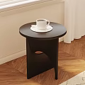 Modern Black Round Top Side Table With White Coffee Cup On Wooden Floor