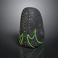 Black Stone Sculpture With Intricate Glowing Green Pattern And Decorative Design