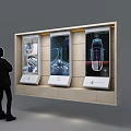 Person Standing In Front Of Three Side By Side Tech Product Display Screens