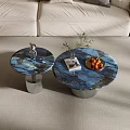 Round Blue Marble Coffee Tables With Silver Ribbed Bases And Decorative Figurine Plant Fruit Plate