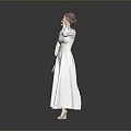 Woman in White Long Dress Standing with Hand Near Face on Grey Reflective Floor Background