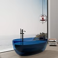 Blue Glass Bathtub in Modern Bathroom with Ocean View Black Faucet and Stack of Books