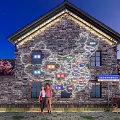 Check in Photo Spot With China Map Projection On Brick Building Cherry Blossom Trees Night