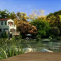 Scenic Lakeside Natural Landscape With Green Trees Red Roof House And Wooden Deck