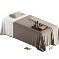 Comfortable Massage Bed With Beige Sheet Pillow Oil Bottles On Tray And Slippers