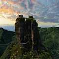 Scenic Mountain Cliff With Ancient Buildings And Sunset Sky Over Green Hills