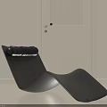 Black Wooden Lounge Chair With Curved Shape And Cushion In Minimalist Interior