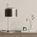 Modern Table Lamp With Silver Base Gray Shade And Glass Vase With Pink Flowers