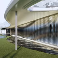 Modern Building Exterior Wall With Curved Design And Wooden Panels Glass Elements Grass And Pool