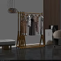 Gold Floor Standing Clothes Rack With Hanging Dresses And Modern Interior Decor
