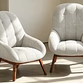 Two Modern Light Gray Upholstered Armchairs with Wooden Legs in Bright Interior