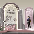 Secret Garden Themed Display With Arched Structures Person On Steps And Flower Decorations