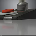 White Handheld Power Tool With Red Button And Black Base Stand