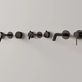Three Modern Black Faucets Mounted On White Wall In Sleek Design
