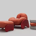 Stylish Orange Velvet Lounge Chair With Matching Ottoman And Comfortable Curved Design