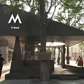 Modern M Stand Architectural Space With Black Roof Trees And Outdoor Bench Pedestrians