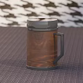 Wooden Mug With Black Lid And Handle On Woven Mat Houndstooth Background
