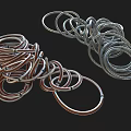 Copper And Silver Coiled Metal Rings Twisted Together On Black Background