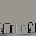 Multiple Black And White Faucets Arranged Against Grey Background