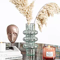 Glass Top Coffee Table With Walnut Wood Sphere Bases Candles Books Sculpture And Pampas Grass