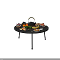 Round Fire Pit Table With Assorted Fruits Nuts Pastries And Teapot On Stand