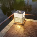 Square Lattice Design Outdoor Light On Wooden Deck By Waterfront With Warm Illumination