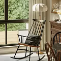 Comfortable Leisure Chair In Cozy Living Room With Wooden Shelves And Decorative Plants