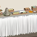 Inflatable Themed Buffet Table With White Tablecloth And Assorted Food Items